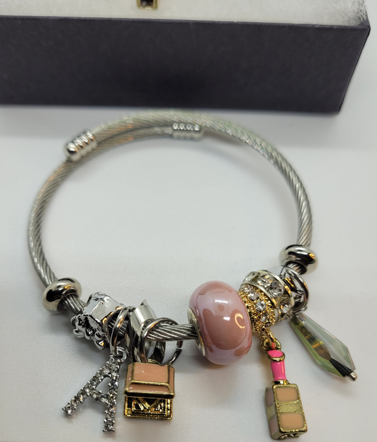 Pink lipstick and A charm bracelet