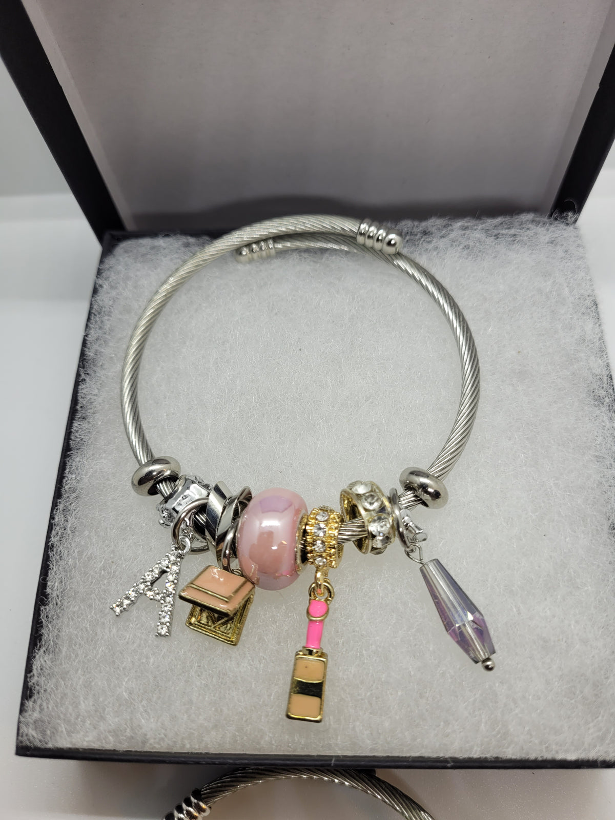 Pink lipstick and A charm bracelet
