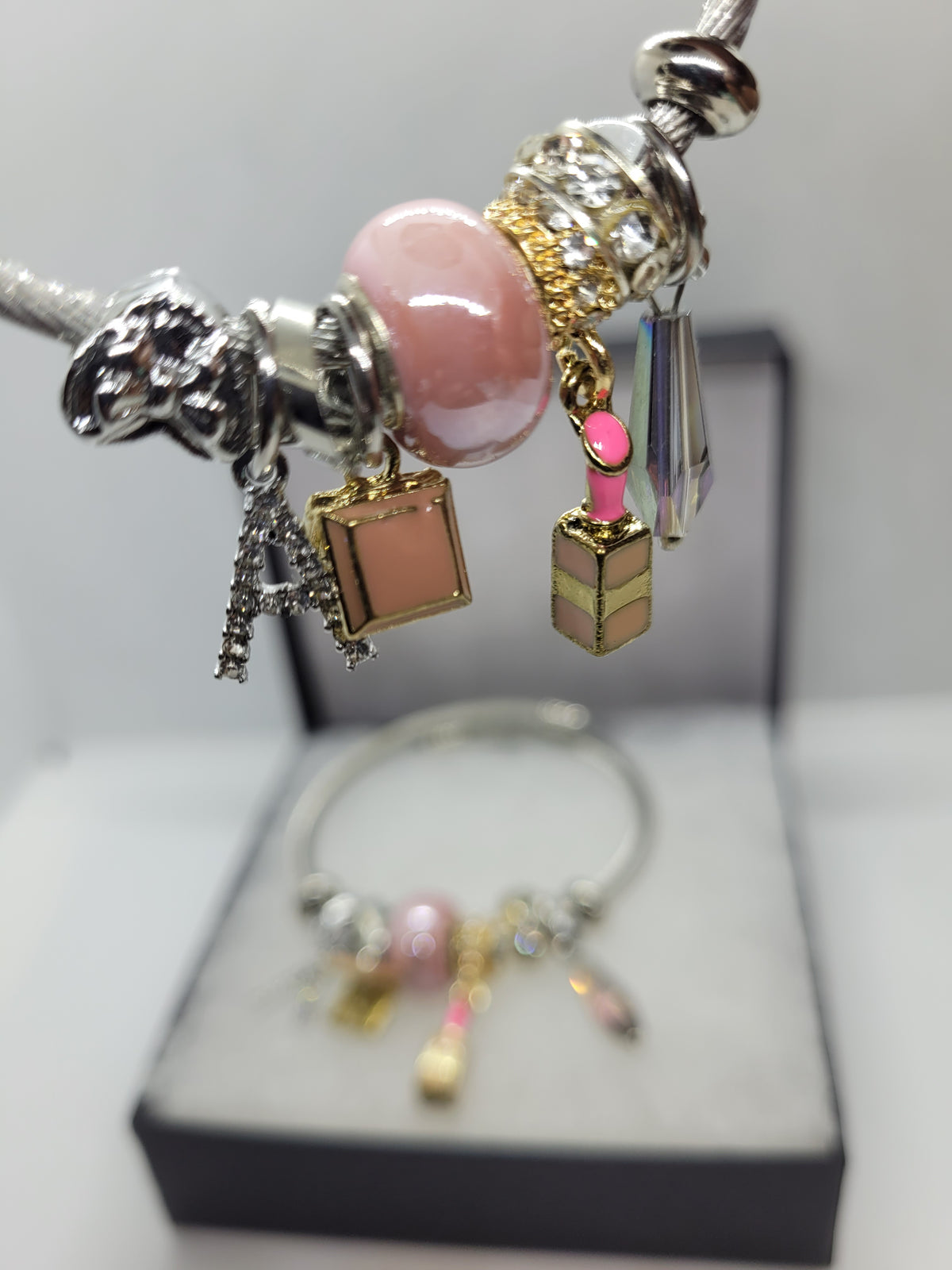 Pink lipstick and A charm bracelet