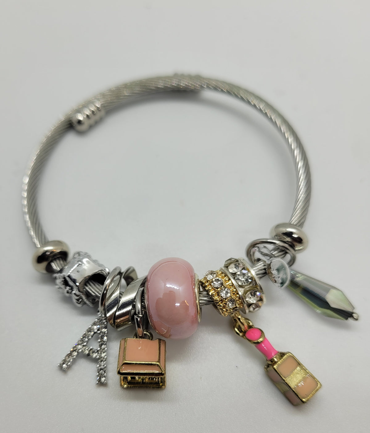Pink lipstick and A charm bracelet